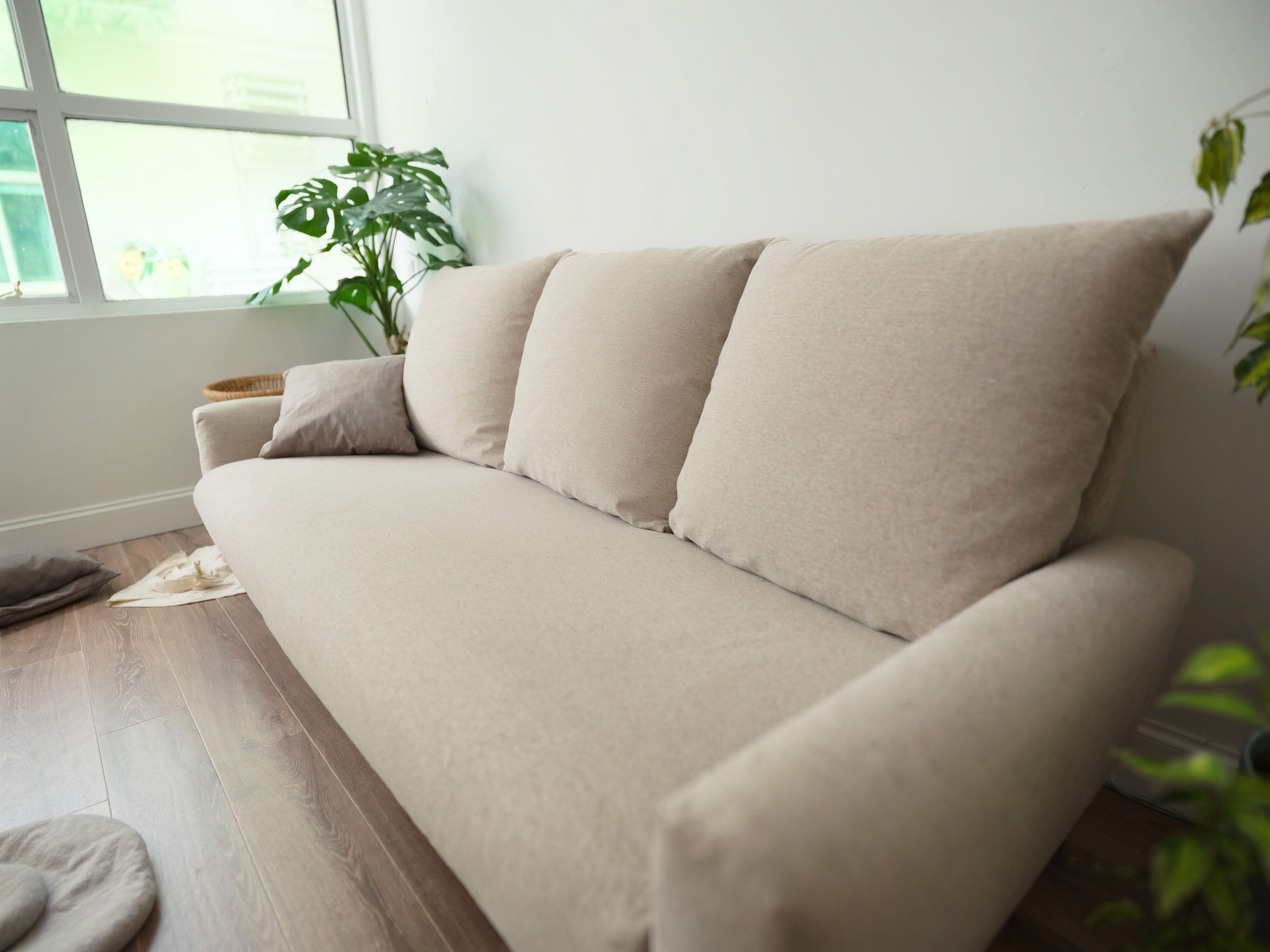 Freshly deep-cleaned beige fabric sofa in a bright, sunlit Singapore living room